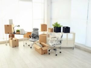 3. Office furniture and boxes arranged in an empty room, highlighting Fk Removals' office removal services in Hornchurch, London.